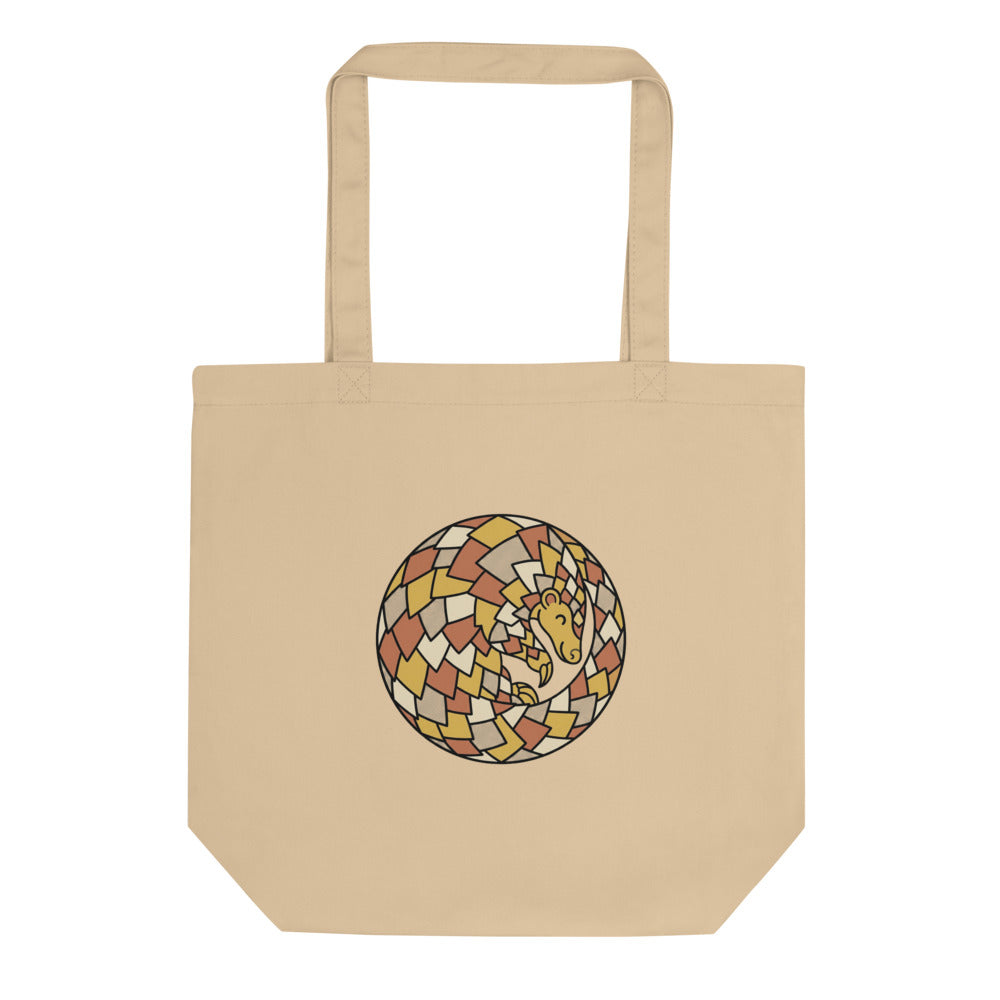 Tote bag pangolin en toile de coton, illustration line-art géométrique palette moutarde terracotta vert forêt, vue de face sur fond blanc