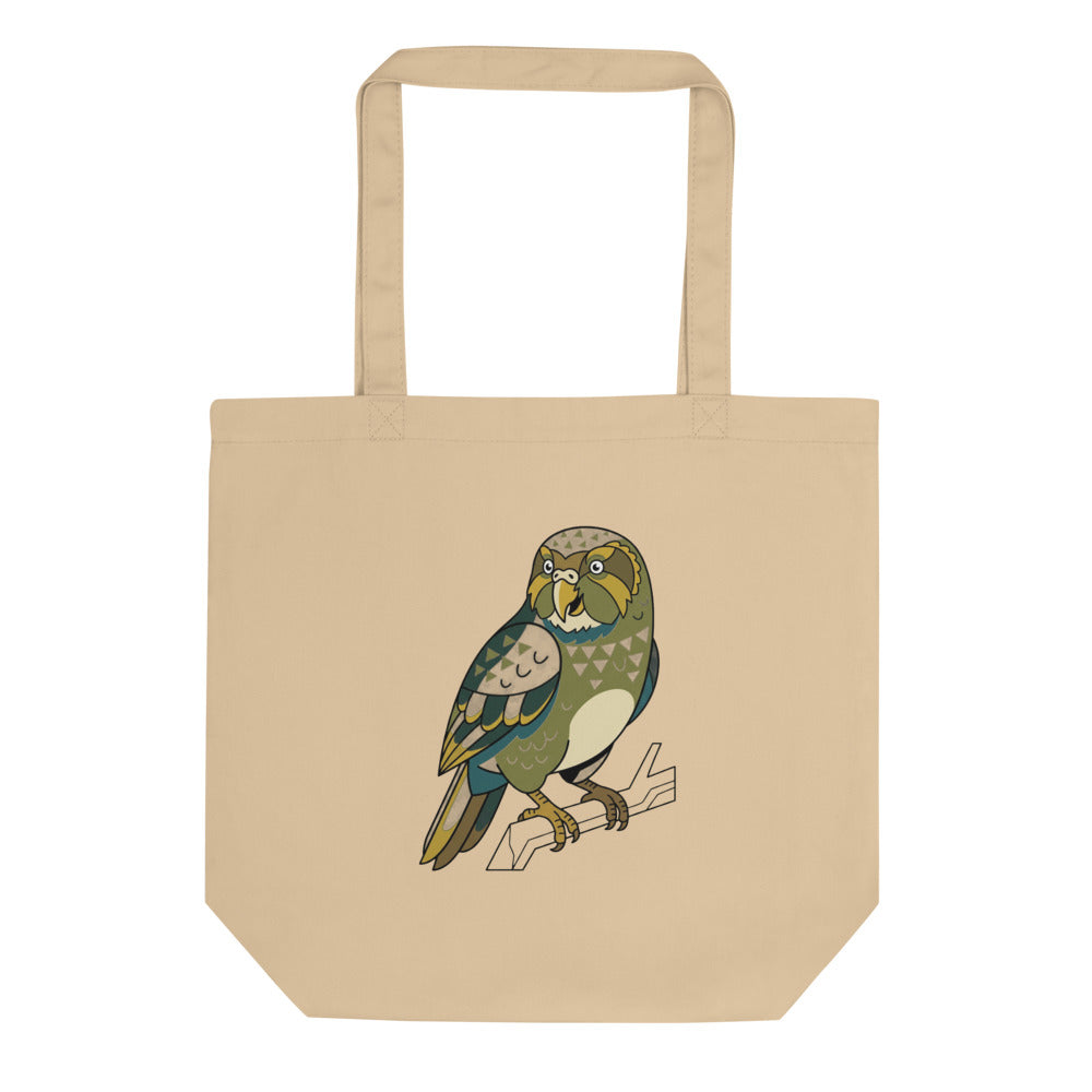 Tote bag kakapo illustration line-art de face, aplats vert forêt et accents moutarde sur toile de coton blanc, contours encre noire géométriques